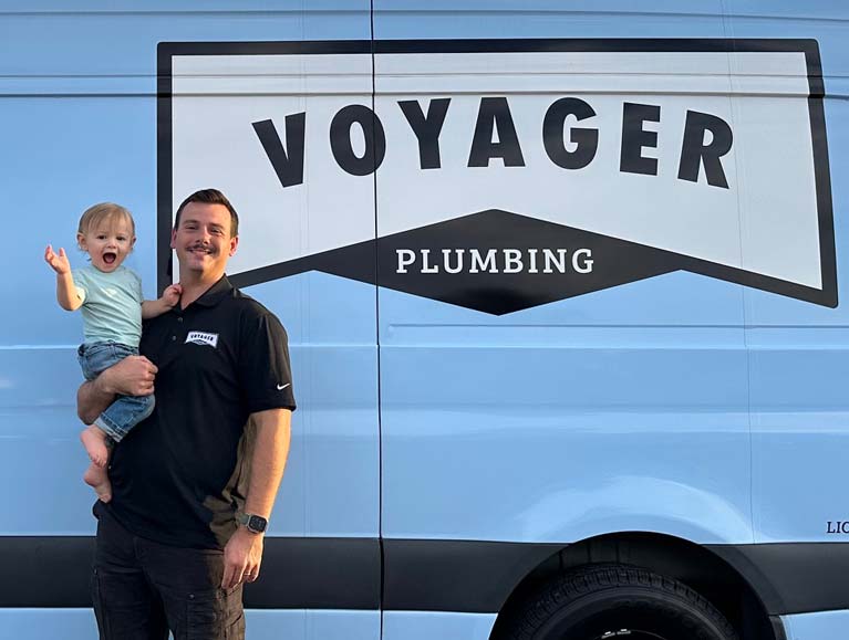owner with son by branded trucki
